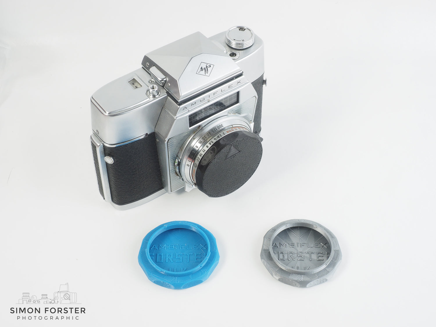 Five individual body caps which have been designed to fit contax and kiev camera body's, are being showcased in plain white background read for sale. Two of the body caps are black, two are red and one is light blue.