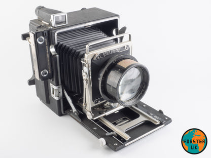 A vintage Speed Graphic camera with a Dallmeyer Pentac lens attached, mounted on a forster uk lens board.