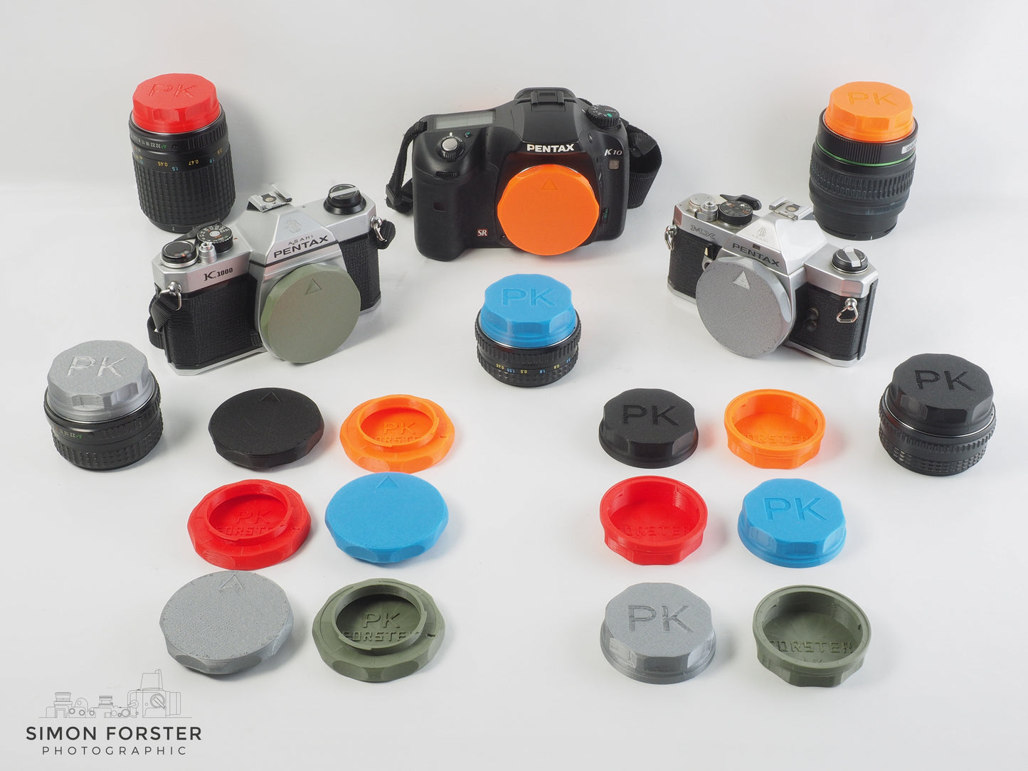 Assorted 3D-printed PK mount rear lens caps and body caps in various colours for Pentax K mount cameras and lenses by Forster UK.